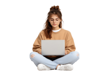 Young woman with glasses sitting cross legged using a laptop, isolated on transparent background
