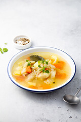 Clear soup with white fish and vegetables