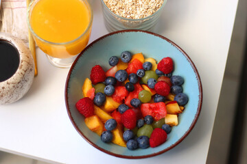 Assortment of various breakfast foods and drinks on the white table. Selective focus.