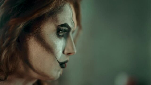 Closeup portrait of strong woman with stage makeup, self-confident person. Young adult actress preparing to movie filming or theatrical performance, psychological disorders and split personality