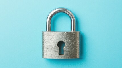 Fototapeta premium A silver padlock with a sleek design resting on a soft blue background, minimalist and modern