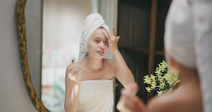 Indian young adult gen z woman lady teen girl female wrapped towel on head and body look mirror use fresh foam soap apply wet dry cheek take sink water hand splash on face do self skin care day home