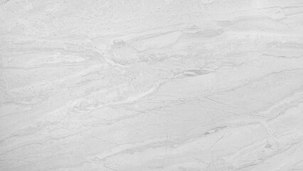 A white and gray marble wall with a pattern of swirls and lines. The wall is smooth and shiny, giving it a luxurious and elegant appearance. The pattern on the wall is reminiscent of a flowing river