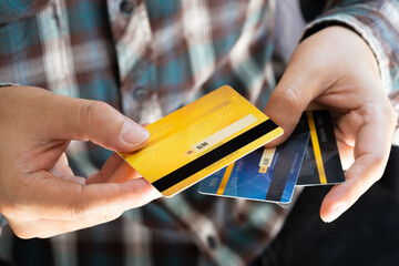 Man holding credit cards and he is choosing a credit card to pay and spend Payment for goods via...