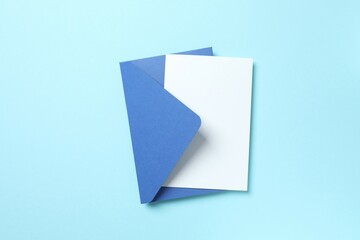 White paper card with blue envelope on color background