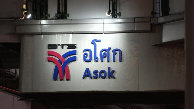 BANGKOK, THAILAND - AUGUST 2024 : Asok BTS Skytrain Station entrance at night, a key point for commuters and tourists exploring Bangkok's vibrant Sukhumvit area.