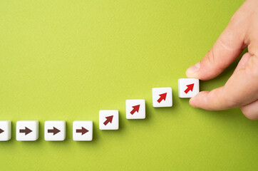 The hand points upwards towards the arrows. Forced increase of indicators or creation of conditions...