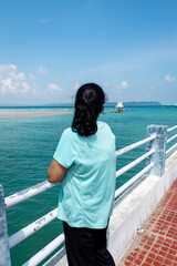Fototapeta premium isolated girl looking at dramatic blue sky over sea horizon at day