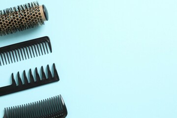 Professional combs and hairdresser tools on color background, top view