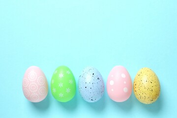Happy Easter card. Easter eggs on color background, top view