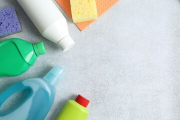 Many different house cleaning products on gray background, top view