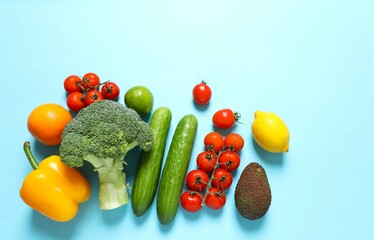 Clean healthy eating habits concept. Fruits, herbs, greens and vegetables mix, colorful juicy organic detox smoothie juice ingredients, color background. Vegan vegetarian diet food