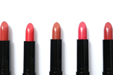 Obraz premium Multi-colored lipsticks isolated on a white background