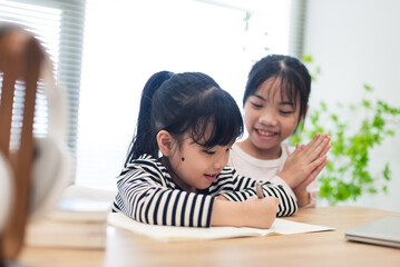 Asian two little girl studying together at home