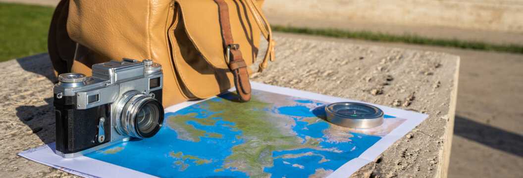 Map, backpack and camera, travel concept