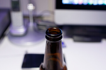 Close-up view of a beverage bottle with a blurred background showcasing a modern workspace and...