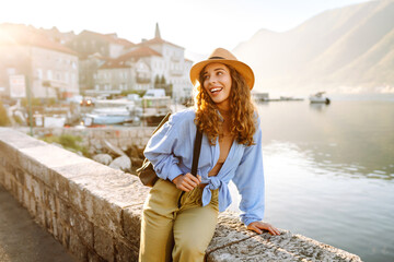 Obraz premium Happy female tourist exploring new city at summer. Europe travel. Lifestyle, vacation, tourism, nature, active life