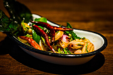 Jar of picked mustard greens with chili and Fish sauce served in dish