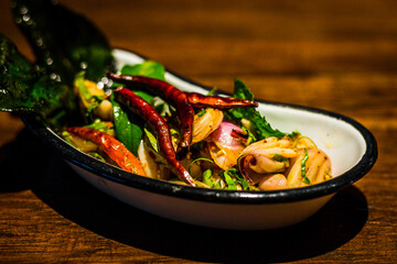 Jar of picked mustard greens with chili and Fish sauce served in dish