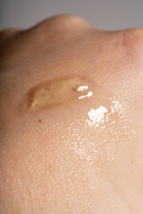 Cosmetic texture gel swatch on woman hand . Skin care product sample on the skin