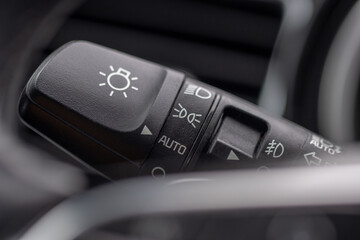 The light switch panel on a passenger car dashboard.