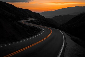 Fototapeta premium Serene Sunset Drive: Winding Road Through Majestic Mountains