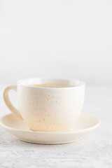 A cup of cappuccino coffee on the table. Vertical orientation.