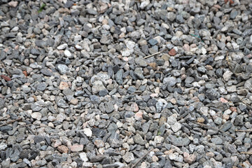 Granules for construction. Gray granite stone background.  Texture of gray and white rocks.