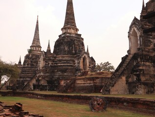 Fototapeta premium Buddha,fine arts,thailand Ancient temple ruins with tall spires and historical architecture.