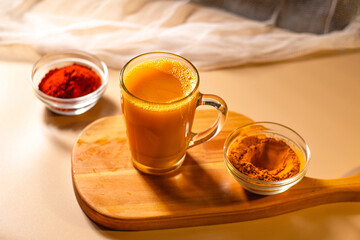 Immunity drink with turmeric powder. Turmeric tea. Trendy healthy drink with curcuma spices. Herbal beverage for health and normal bowel function