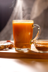 Immunity drink with turmeric powder. Turmeric tea. Trendy healthy drink with curcuma spices. Herbal...