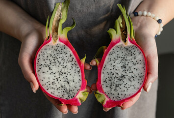 Hands Holding Sliced Pitahaya or Dragon Fruit