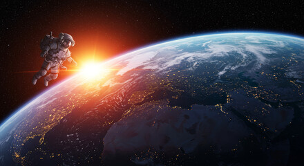Fototapeta premium Astronaut exploring space with earth and sunrise