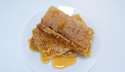 honey flowing over natural honeycombs
