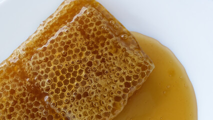 honey flowing over natural honeycomb