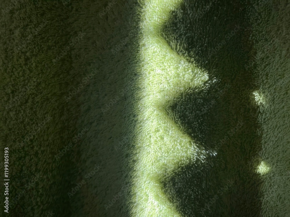 Poster subtle sunlight creating geometric patterns on textured green towel fabric, perfect for abstract des