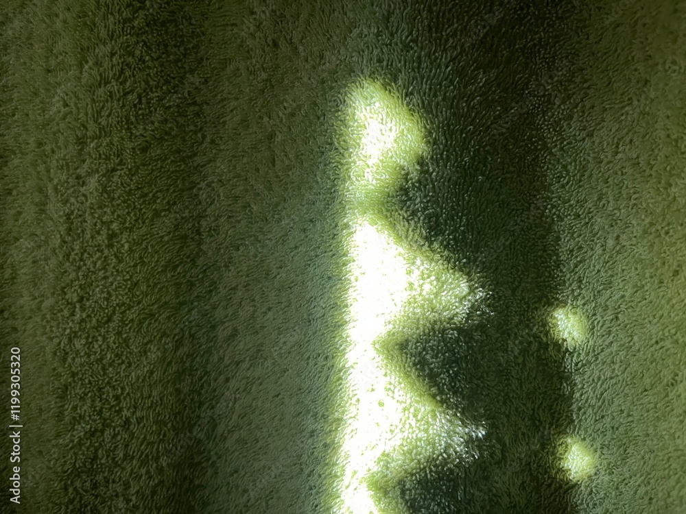 Poster subtle sunlight creating geometric patterns on textured green towel fabric, perfect for abstract designs, background concepts, or natural themes