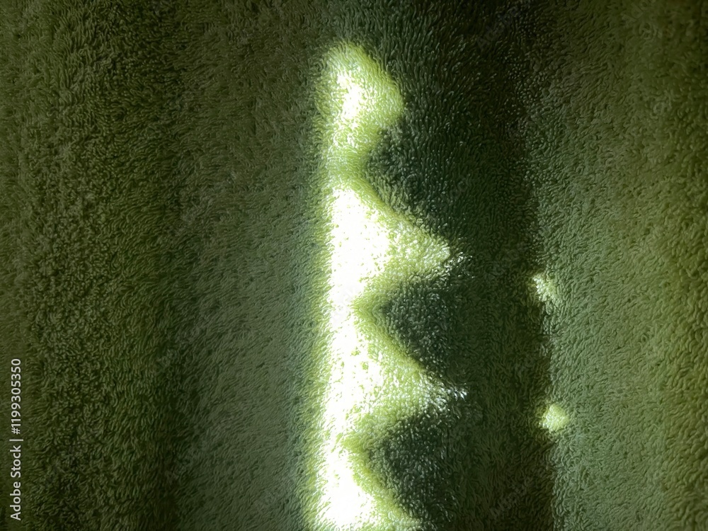Poster subtle sunlight creating geometric patterns on textured green towel fabric, perfect for abstract des