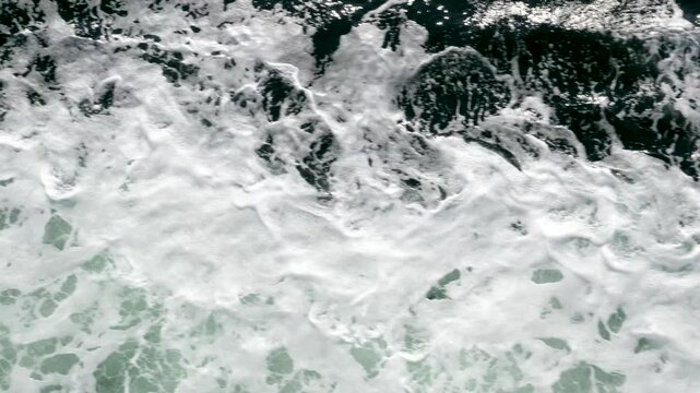 ocean waves overview in portugal Sea waves with foam near the shore. Sea surface aerial view 4K Beautiful texture of big power blue ocean waves with whitewash. Aerial top-view footage of sea