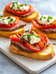 Bruschetta with roasted peppers, creamy goat cheese, and fresh oregano.