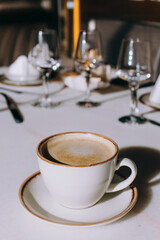 Cappuccino in a ceramic mug in an elegant cafe, coffee taste, caffeine, lunch, brunch, caffe art