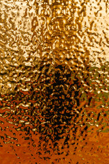 stamped gold-colored iron sheet. textured tin sheet on the wall