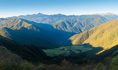 Obraz premium Breathtaking panoramic view of a serene valley nestled amidst majestic mountains, bathed in the golden light of sunrise or sunset.