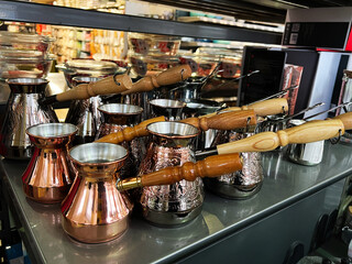 Traditional Copper Coffee Pots Displayed on a Store Shelf in a Kitchenware Shop