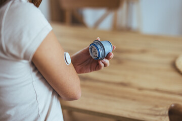 Person Using Continuous Glucose Monitor for Diabetes Management at Home
