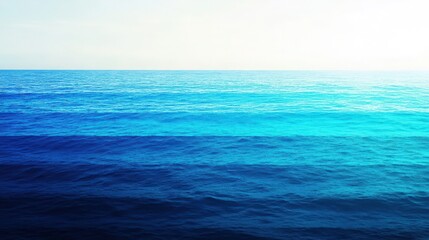 Fototapeta premium Gradient of Ocean Waters with Light Sky Above creating a stunning and calming sea view