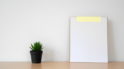 Minimalist plant display with blank canvas modern home office photography bright interior close-up aesthetic inspiration