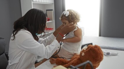 Woman doctor examining young girl with stethoscope in a clinic room, creating a nurturing medical environment highlighting pediatric healthcare and patient interaction.