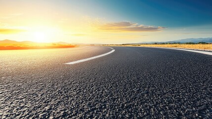 Fototapeta premium Desert highway at sunset with clear blue sky and empty space for text usage