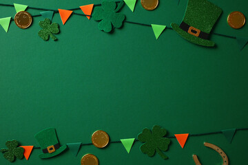 St Patricks Day concept. Flat lay composition with shamrocks, leprechaun hats, gold coins, and...